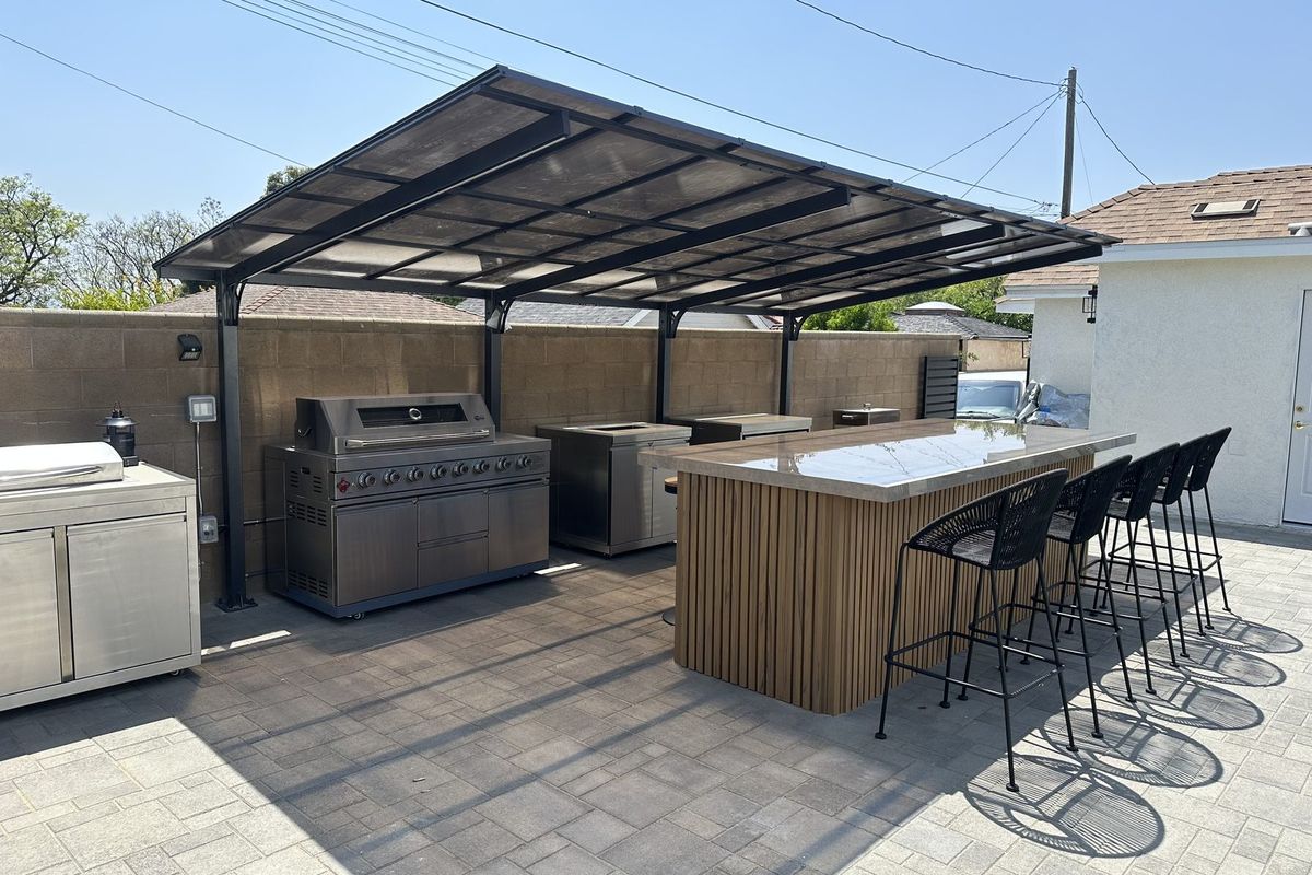Covered outdoor kitchen with grill and bar at Elm, Burbank